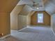 Large bonus room with neutral carpet, sloped ceilings, and a window for natural light at 187 Eagles Club Dr, Stockbridge, GA 30281