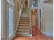 Welcoming foyer features hardwood floors, a staircase leading to upper floors, and an elegant entry door at 187 Eagles Club Dr, Stockbridge, GA 30281
