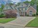 Beautiful two story home with manicured lawn, brick accents, and a two car garage at 187 Eagles Club Dr, Stockbridge, GA 30281