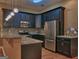Modern kitchen featuring stainless steel appliances, granite countertops, and stylish lighting at 187 Eagles Club Dr, Stockbridge, GA 30281
