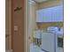 Functional laundry room with ample storage cabinets, sink, and modern washer and dryer units at 187 Eagles Club Dr, Stockbridge, GA 30281