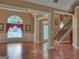 Open concept living space with gleaming hardwood floors, large window, and staircase at 187 Eagles Club Dr, Stockbridge, GA 30281
