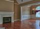 Spacious living room featuring hardwood floors, a fireplace, and abundant natural light at 187 Eagles Club Dr, Stockbridge, GA 30281