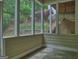 Screened porch with views of the garden, landscaping and exterior of the home at 187 Eagles Club Dr, Stockbridge, GA 30281