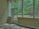 Relaxing screened porch with views of the professionally landscaped backyard at 187 Eagles Club Dr, Stockbridge, GA 30281