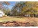 Spacious backyard with mature trees, a shed, and a house with a deck at 75 Antioch Rd, Mcdonough, GA 30252