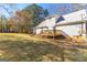 Backyard featuring a deck, a lawn, and a house with white siding at 75 Antioch Rd, Mcdonough, GA 30252