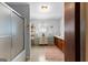Bathroom with a shower, neutral tile, vintage dresser, and built-in cabinets at 75 Antioch Rd, Mcdonough, GA 30252