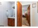 Bathroom with patterned wallpaper, wood vanity, and decorative mirror at 75 Antioch Rd, Mcdonough, GA 30252
