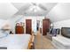 Bedroom with seating area, TV, wood furniture and multiple doors at 75 Antioch Rd, Mcdonough, GA 30252