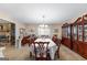 Formal dining room with stone fireplace, large table with chairs, and china cabinet at 75 Antioch Rd, Mcdonough, GA 30252