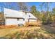 Exterior view of home featuring a deck, white siding, and a metal roof at 75 Antioch Rd, Mcdonough, GA 30252