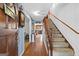 Inviting foyer featuring hardwood floors, staircase, and views to the kitchen and living spaces at 75 Antioch Rd, Mcdonough, GA 30252