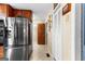 The kitchen hallway includes stainless steel refrigerator and lots of pantry space at 75 Antioch Rd, Mcdonough, GA 30252