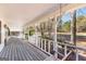 Spacious covered porch with swing, offering serene views of the surrounding landscape at 75 Antioch Rd, Mcdonough, GA 30252