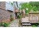 Charming backyard deck featuring multiple levels with stairs, brick exterior and lush landscaping at 830 Montego Sw Way, Lilburn, GA 30047
