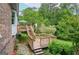 Charming backyard deck featuring multiple levels with stairs, brick exterior and lush landscaping at 830 Montego Sw Way, Lilburn, GA 30047