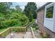 Inviting backyard patio with a stone pathway, landscaped garden, and steps leading up to the house at 830 Montego Sw Way, Lilburn, GA 30047