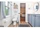 Bathroom with updated fixtures, a decorative shelf, and wood-style flooring at 830 Montego Sw Way, Lilburn, GA 30047