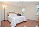 Comfortable bedroom features hardwood floors, a ceiling fan, and windows that let in lots of natural light at 830 Montego Sw Way, Lilburn, GA 30047