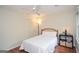 Cozy bedroom with hardwood floors, a ceiling fan, and bright windows creating a comfortable and inviting space at 830 Montego Sw Way, Lilburn, GA 30047