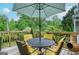Charming outdoor deck with comfortable seating under a colorful umbrella, perfect for enjoying the surrounding greenery at 830 Montego Sw Way, Lilburn, GA 30047