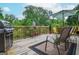 Relaxing deck area with a grill, comfortable seating, and lush greenery, perfect for outdoor gatherings and enjoyment at 830 Montego Sw Way, Lilburn, GA 30047