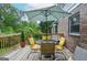 Spacious deck featuring a dining set with a colorful umbrella, ideal for outdoor dining and relaxation in a serene setting at 830 Montego Sw Way, Lilburn, GA 30047