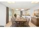 Sunlit dining area with a rustic wood table, decorative dresser, and inviting neutral tones at 830 Montego Sw Way, Lilburn, GA 30047