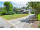 Exterior view of a beautiful brick and siding house with green lawn, trees, and long drive way at 830 Montego Sw Way, Lilburn, GA 30047