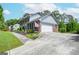 Charming brick and siding home with a two-car garage, well-maintained yard, and driveway at 830 Montego Sw Way, Lilburn, GA 30047
