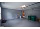 Spacious garage featuring epoxy floors, overhead lighting, and storage, with door to interior at 830 Montego Sw Way, Lilburn, GA 30047