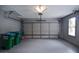 Well-lit garage with a large door, providing ample space for vehicles and storage solutions at 830 Montego Sw Way, Lilburn, GA 30047