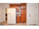 Spacious kitchen with wooden cabinets, white refrigerator, tiled floors and ample pantry storage at 830 Montego Sw Way, Lilburn, GA 30047