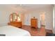 The main bedroom features a dresser, hardwood floors, an ensuite bath, and natural light at 830 Montego Sw Way, Lilburn, GA 30047