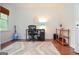 Bright office with hardwood floors and a large rug at 830 Montego Sw Way, Lilburn, GA 30047