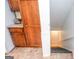 View of the stairway with runner, leading to the basement with wood cabinets and granite counters at 830 Montego Sw Way, Lilburn, GA 30047