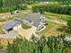 Aerial view highlights the house, pool, barn with garages and a long driveway at 107 Corinth Reserve Pl, Grantville, GA 30220