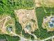 Aerial of the property shows a house, pool, barn, outbuilding, and surrounding woods at 107 Corinth Reserve Pl, Grantville, GA 30220