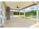Large covered back patio with a ceiling fan overlooking the pool at 107 Corinth Reserve Pl, Grantville, GA 30220