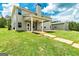 Spacious backyard featuring a covered patio, lush lawn, and an additional outbuilding at 107 Corinth Reserve Pl, Grantville, GA 30220