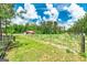 Property with fenced pasture area and a charming red barn nestled among the trees at 107 Corinth Reserve Pl, Grantville, GA 30220