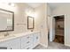 Bright bathroom with double vanity, quartz countertop, framed mirrors, and walk in closet at 107 Corinth Reserve Pl, Grantville, GA 30220