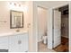 Bathroom featuring a single vanity and view into toilet area and walk-in closet at 107 Corinth Reserve Pl, Grantville, GA 30220