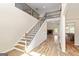 Grand foyer with hardwood floors, an open staircase, and natural light at 107 Corinth Reserve Pl, Grantville, GA 30220