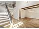 Beautiful foyer featuring an open staircase, hardwood floors, and modern lighting at 107 Corinth Reserve Pl, Grantville, GA 30220