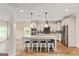 Open concept kitchen with an island, stainless steel appliances, and modern cabinets at 107 Corinth Reserve Pl, Grantville, GA 30220
