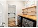Modern laundry room with wooden countertops, front loading washer and dryer, and shelves at 107 Corinth Reserve Pl, Grantville, GA 30220