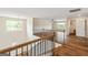 Second story loft area with railing and view to stairs, windows, and a ceiling fan at 107 Corinth Reserve Pl, Grantville, GA 30220
