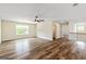 Open concept living room with wood look flooring, natural light, and ceiling fan at 107 Corinth Reserve Pl, Grantville, GA 30220
